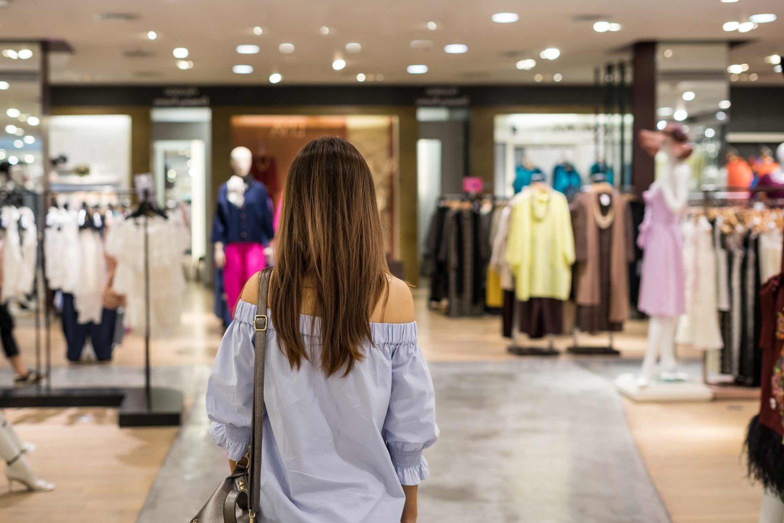 Woman walking into clothing store